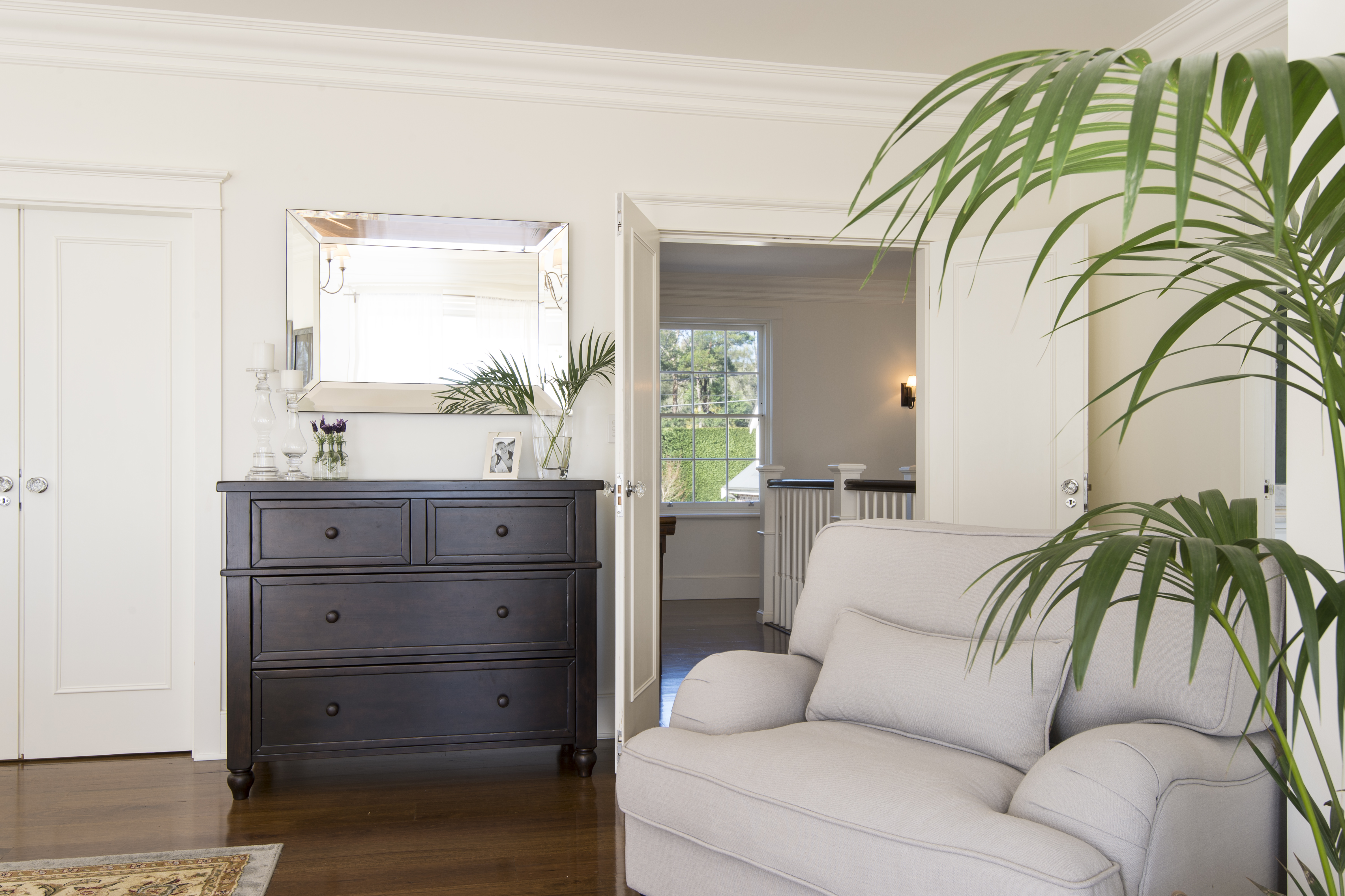 rachel boden interiors designed this bedroom using dark wood light furnishings and greenery in terrey hills Sydney Australia